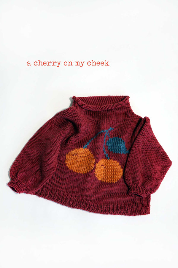 A cherry on may check sweater